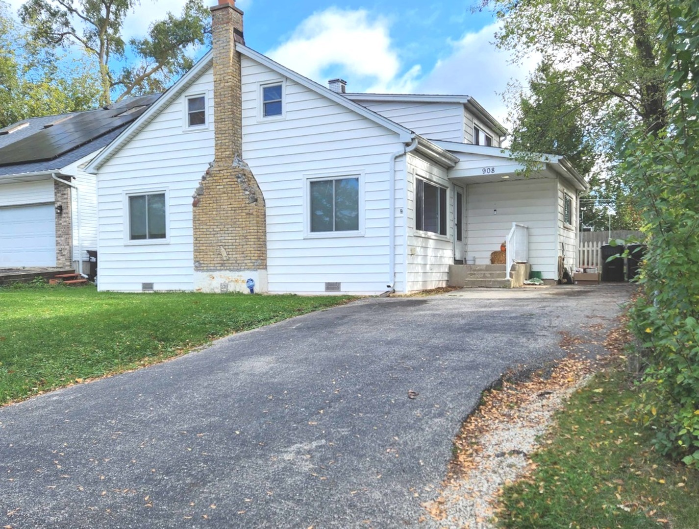a view of a house with a yard and garage