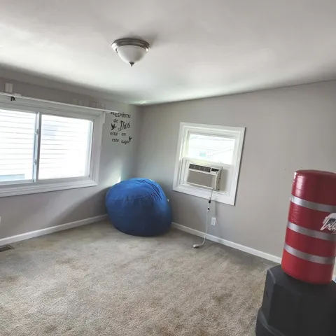 a bedroom with a bed and a television