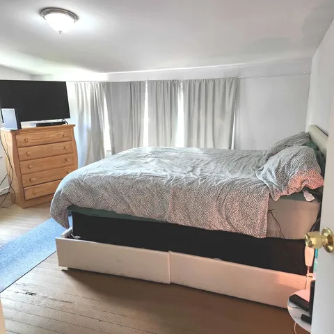 a white toilet sitting next to a shower