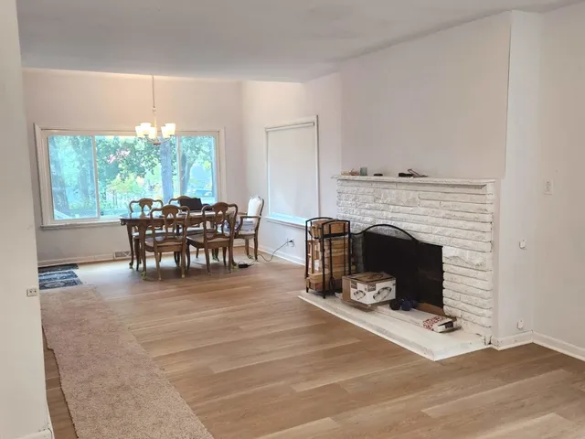 a living room with furniture a fireplace and a table