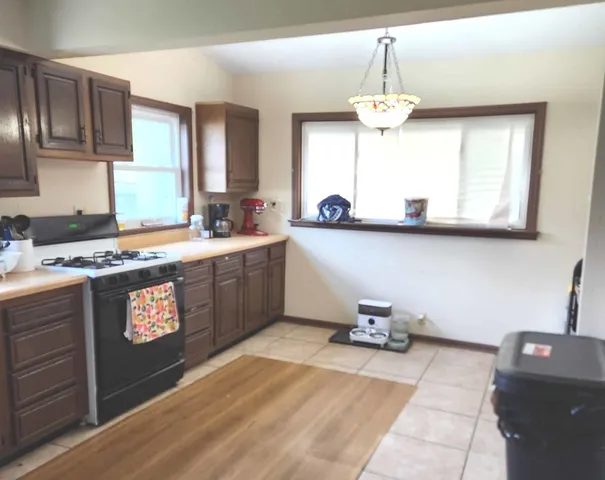 a kitchen with stainless steel appliances granite countertop a sink stove and cabinets