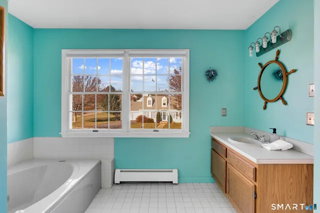 a bathroom with a sink and a large window