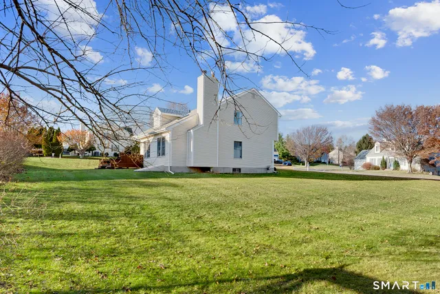 a house view with swimming pool in front of it