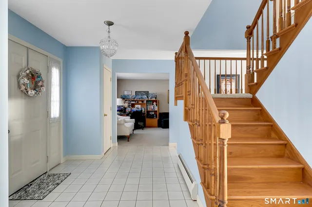 a view of entryway and hall with wooden floor