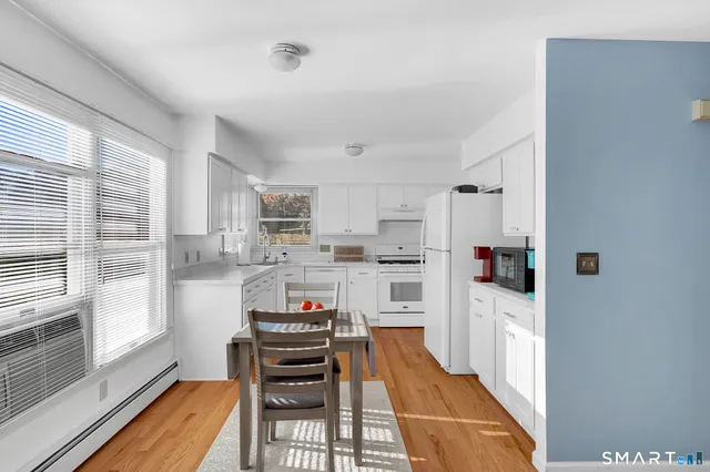 a kitchen with stainless steel appliances a refrigerator and a stove top oven