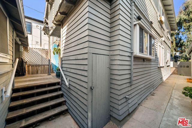 a view of a house with a door and wooden walls