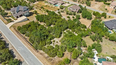 a view of a yard with trees in the background