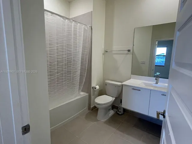 a bathroom with a toilet a sink and shower