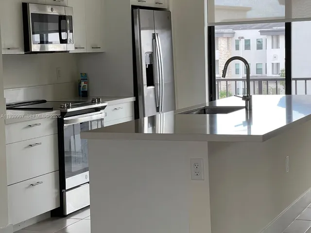 a kitchen with a stove and a refrigerator