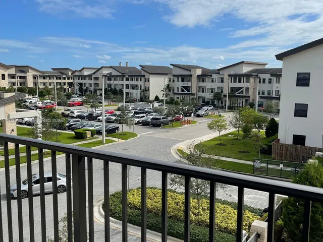 a front view of a house with a yard fountain and outdoor seating