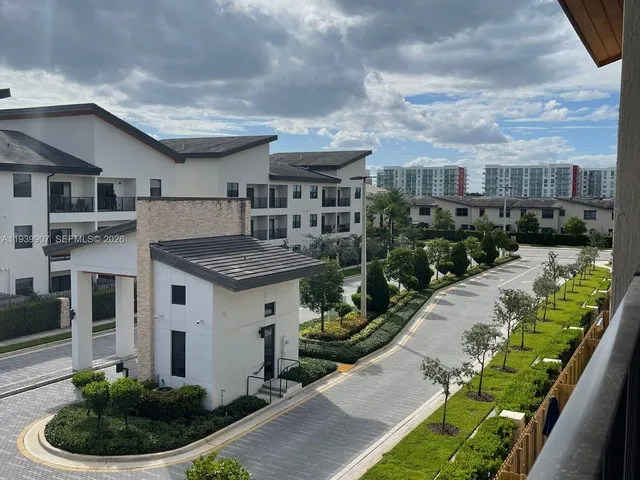 a view of a white house with large windows