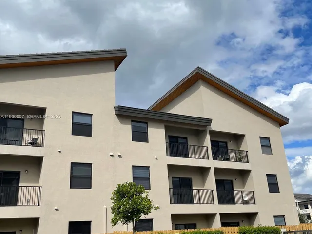 a couple of cars parked in front of a building