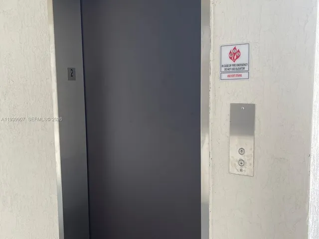 a front view of residential houses with yard and green space