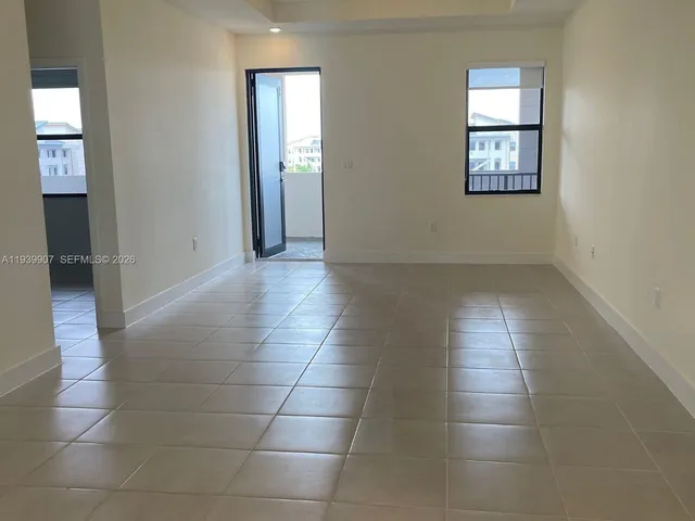 an empty room with windows and entrance