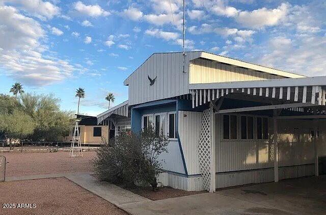 2451 West Cholla Street Apache Junction, AZ 85120 - Photo 11 of 14 a front view of a house with garage
