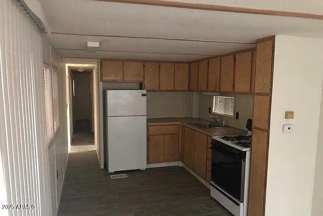 2451 West Cholla Street Apache Junction, AZ 85120 - Photo 9 of 14 a kitchen with a refrigerator stove and cabinets