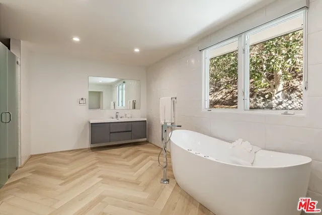 a spacious bathroom with a bathtub and a sink