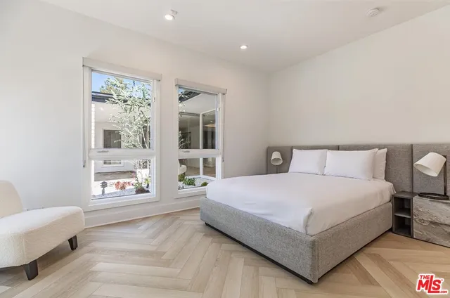 a bedroom with a large bed and a window