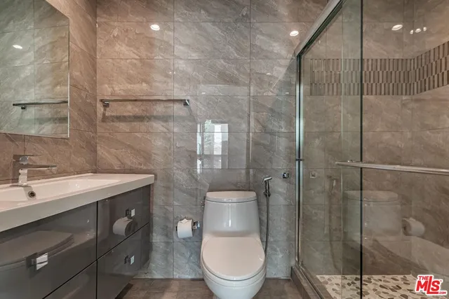 a bathroom with a toilet a sink and mirror