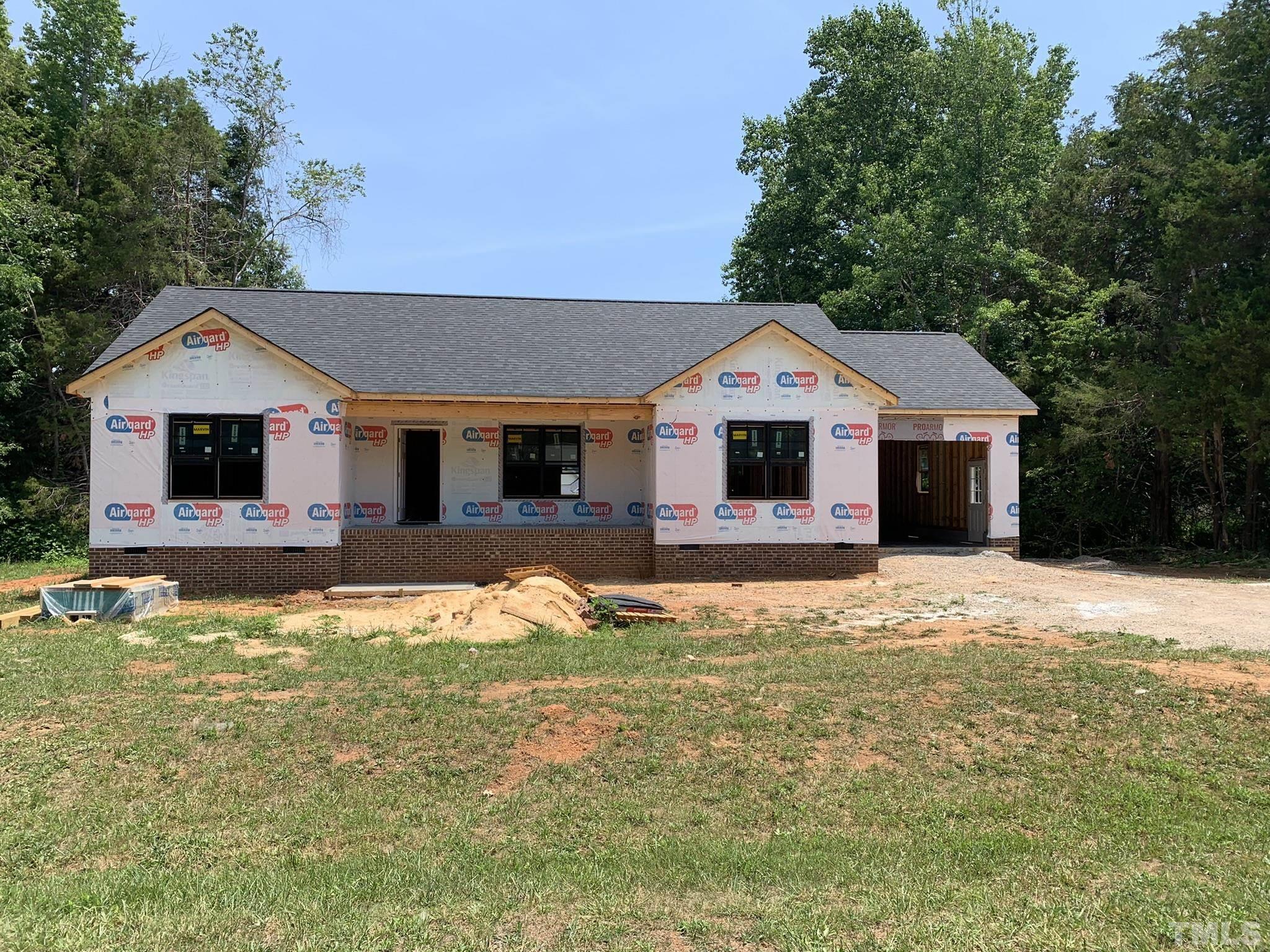 9503 Meredith Drive Rougemont, NC 27572 - Photo 1 of 15 a front view of a house with a yard outdoor seating and garage