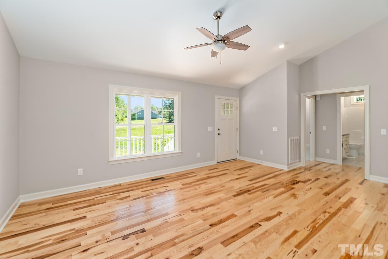 9503 Meredith Drive Rougemont, NC 27572 - Photo 10 of 15 a bedroom with a large bed window and a chandelier