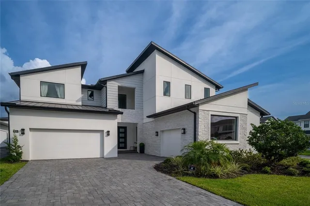 a view of house with yard and parking