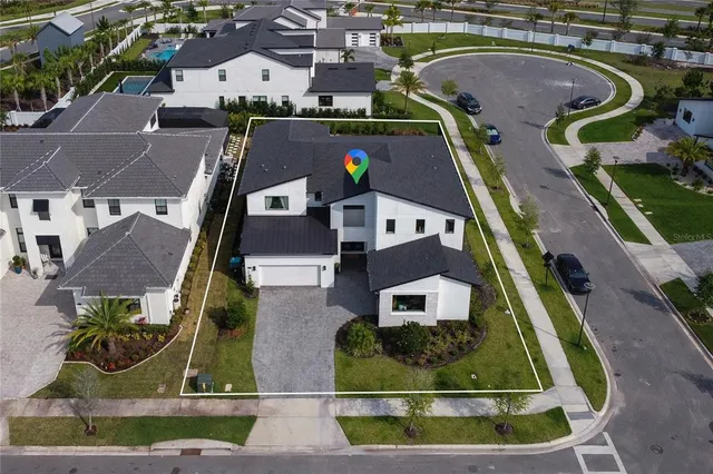 an aerial view of a house with a swimming pool