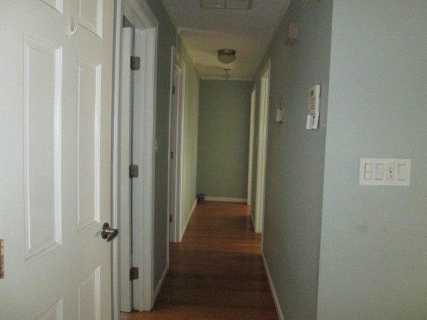 80 Murphy Road Hudson, MA 01749 - Photo 12 of 24 a view of a hallway with a wooden door