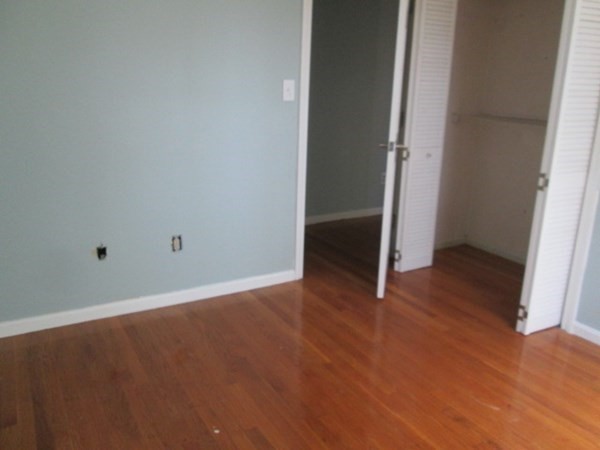 80 Murphy Road Hudson, MA 01749 - Photo 18 of 24 an empty room with wooden floor and entrance