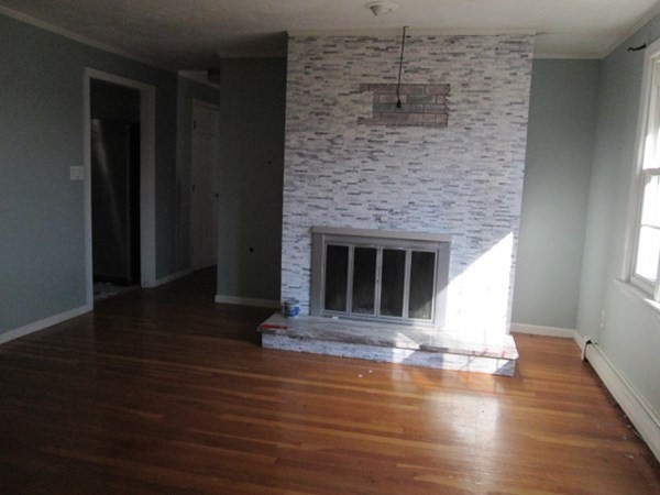 80 Murphy Road Hudson, MA 01749 - Photo 4 of 24 a view of a fireplace with wooden floor