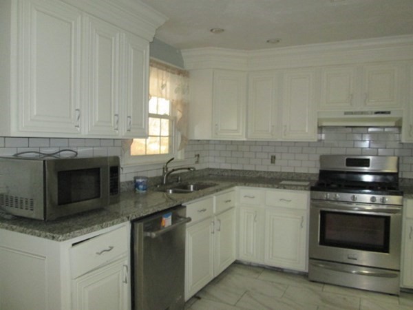 80 Murphy Road Hudson, MA 01749 - Photo 5 of 24 a kitchen with granite countertop white cabinets stainless steel appliances and a sink