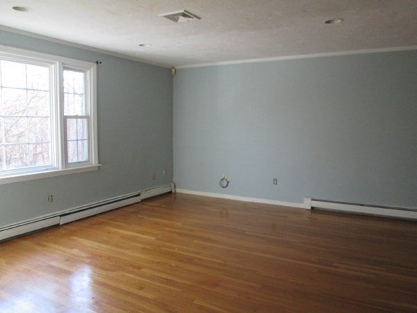 80 Murphy Road Hudson, MA 01749 - Photo 7 of 24 an empty room with wooden floor and windows