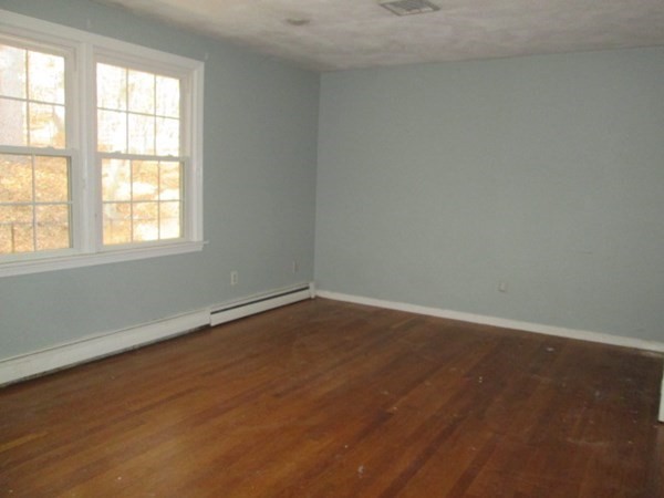 80 Murphy Road Hudson, MA 01749 - Photo 8 of 24 an empty room with wooden floor and windows