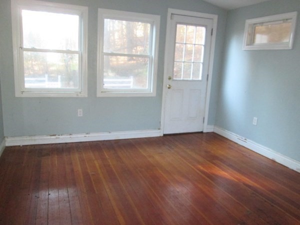 80 Murphy Road Hudson, MA 01749 - Photo 9 of 24 an empty room with wooden floor and windows