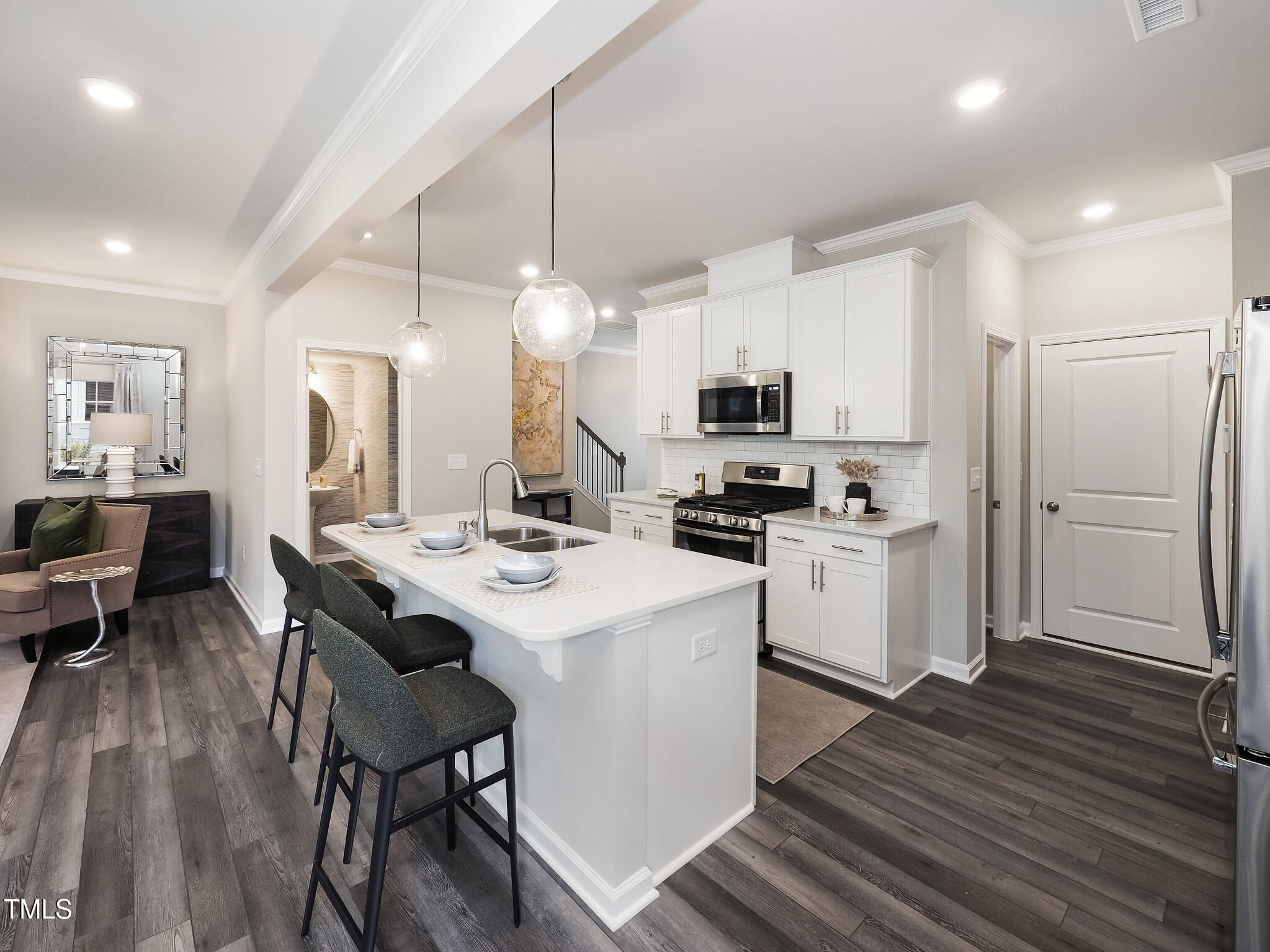 a kitchen with white cabinets and stainless steel appliances