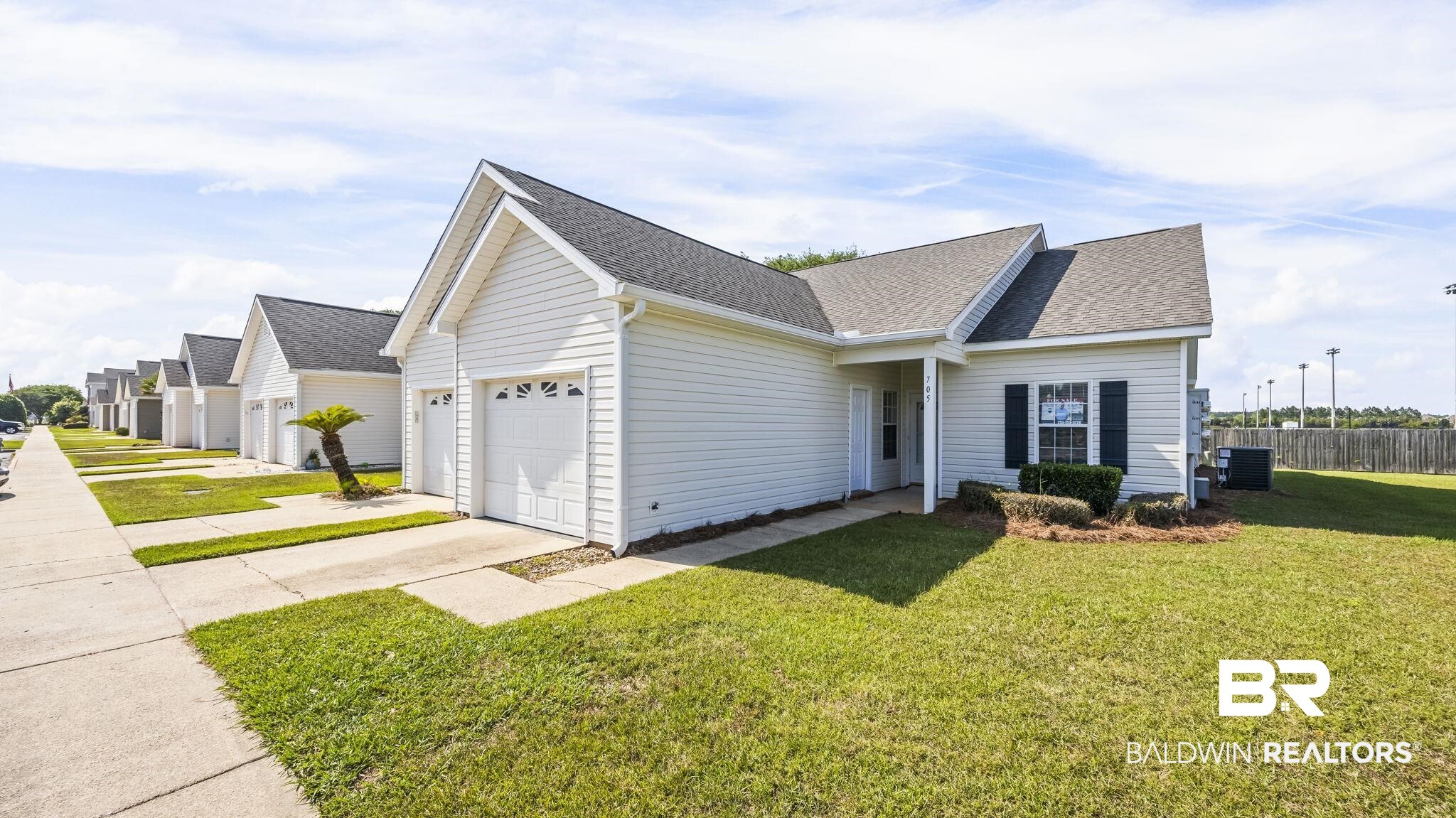 2651 South Juniper Street, Unit 705 Foley, AL 36535 - Photo 3 of 37 Contemporary white siding residence featuring an attached garage, a paved driveway, and a front entry porch