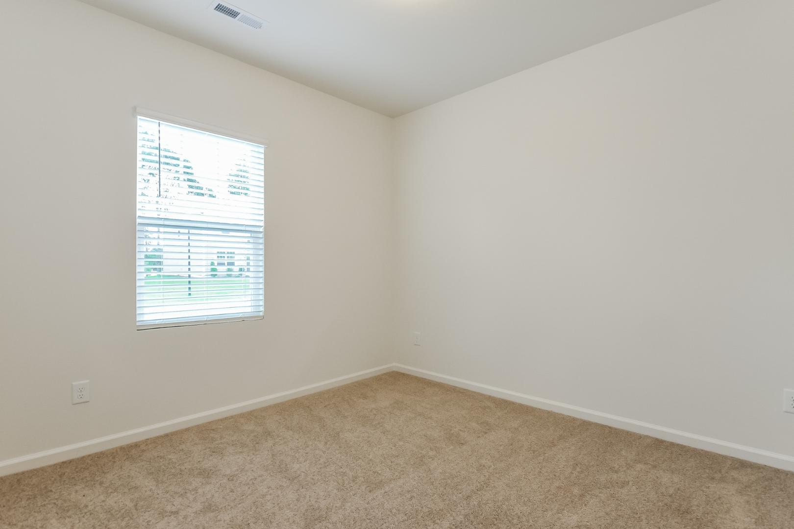 709 Kenyon Spring Drive Zebulon, NC 27597 - Photo 11 of 18 an empty room with a window