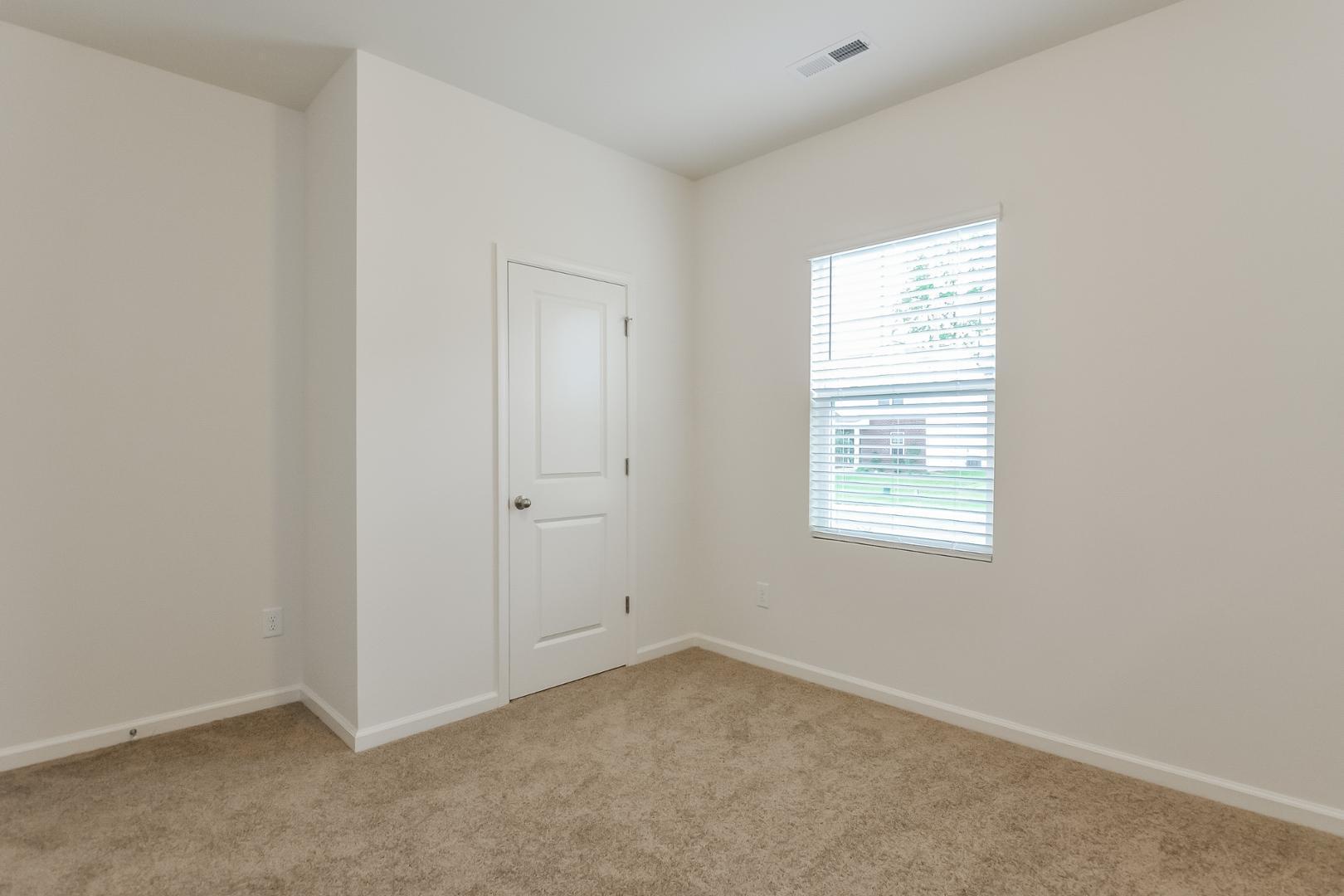 709 Kenyon Spring Drive Zebulon, NC 27597 - Photo 14 of 18 an empty room with windows
