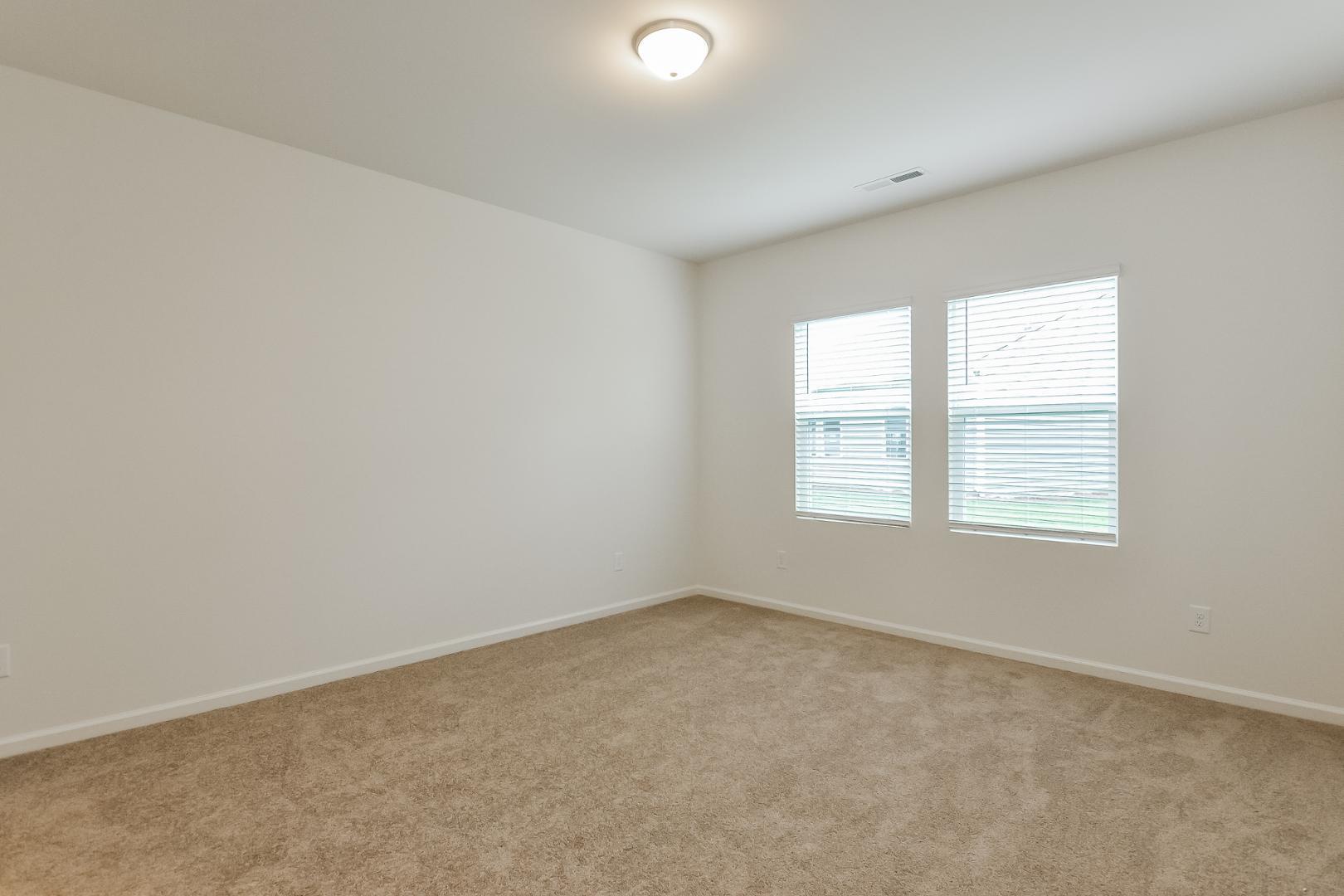 709 Kenyon Spring Drive Zebulon, NC 27597 - Photo 10 of 18 an empty room with a window