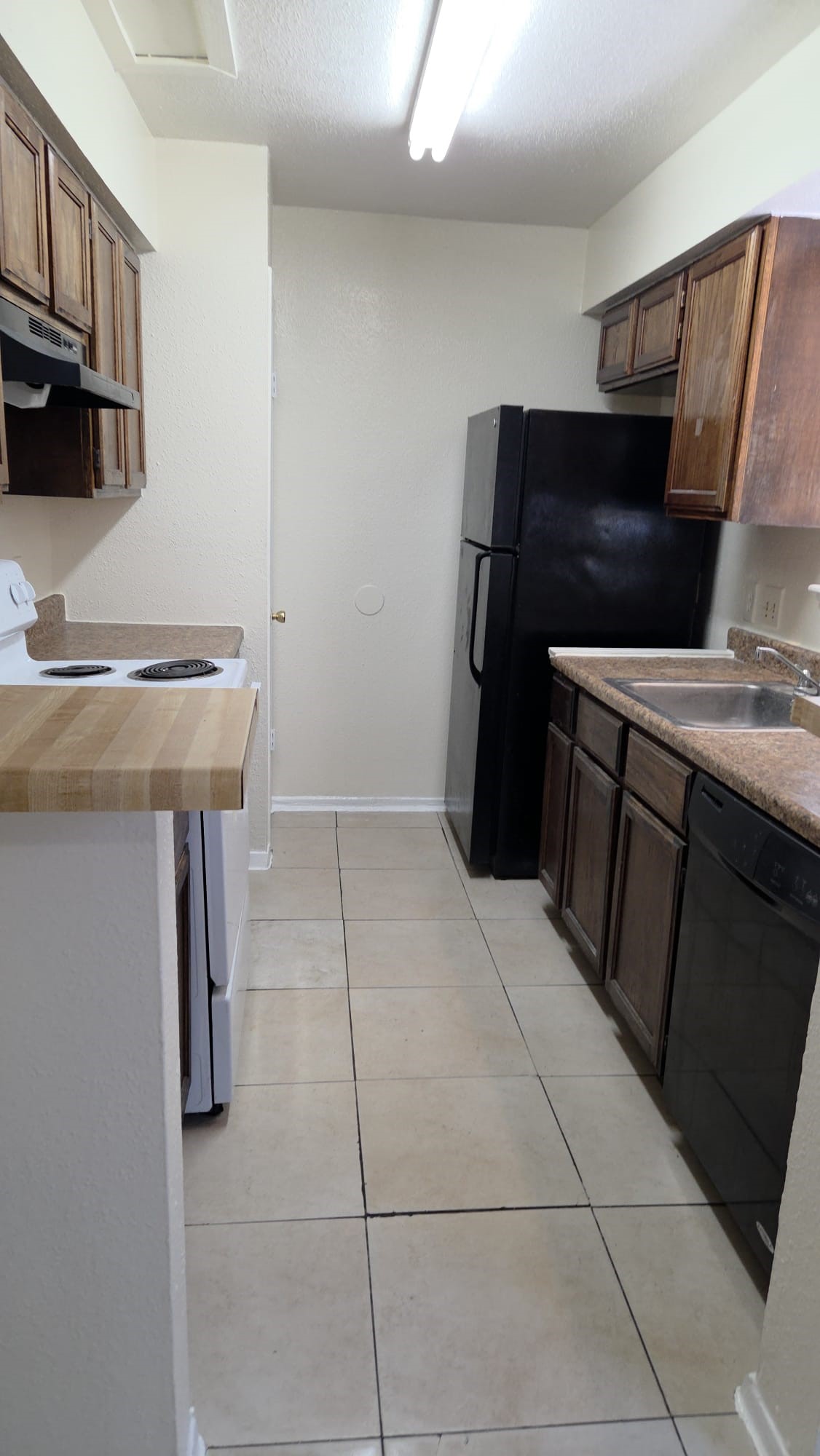 11549 South Kirkwood Road Houston, TX 77099 - Photo 2 of 7 a kitchen with a refrigerator and a stove top oven