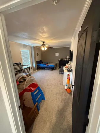 a kitchen with stainless steel appliances a refrigerator a sink dishwasher a dining table and chairs with wooden floor