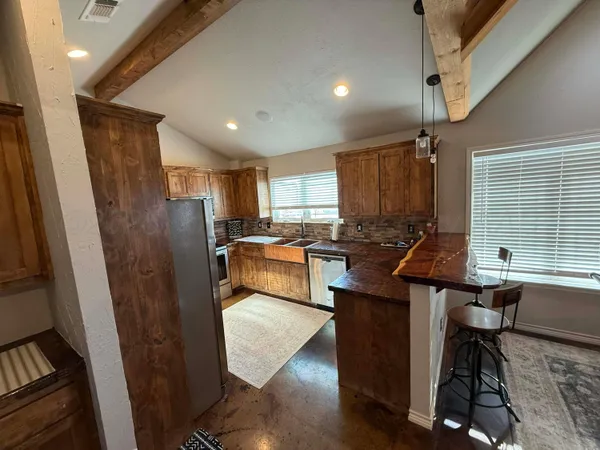 a view of empty room with a window and a ceiling fan