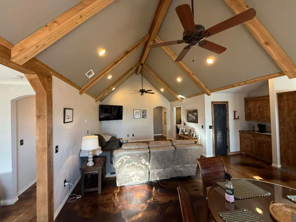 a kitchen with stainless steel appliances granite countertop a refrigerator a stove and a sink with wooden floor