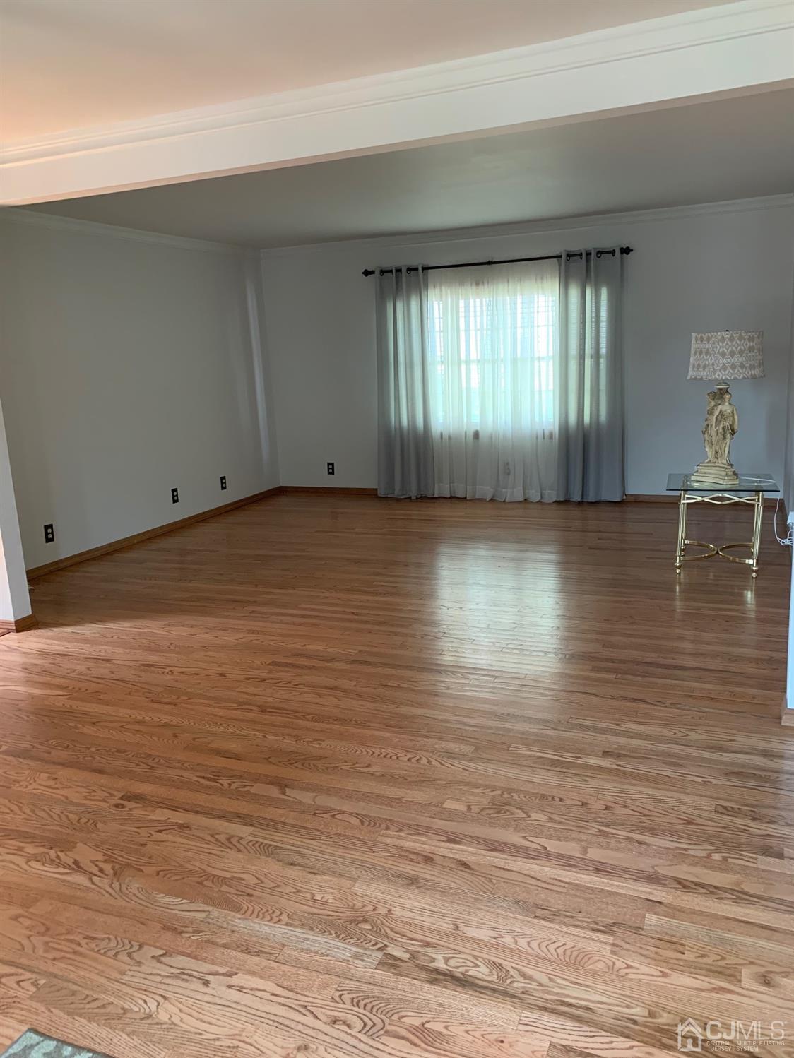 5 Princeton Road Old Bridge, NJ 08859 - Photo 4 of 20 wooden floor in an empty room with a window