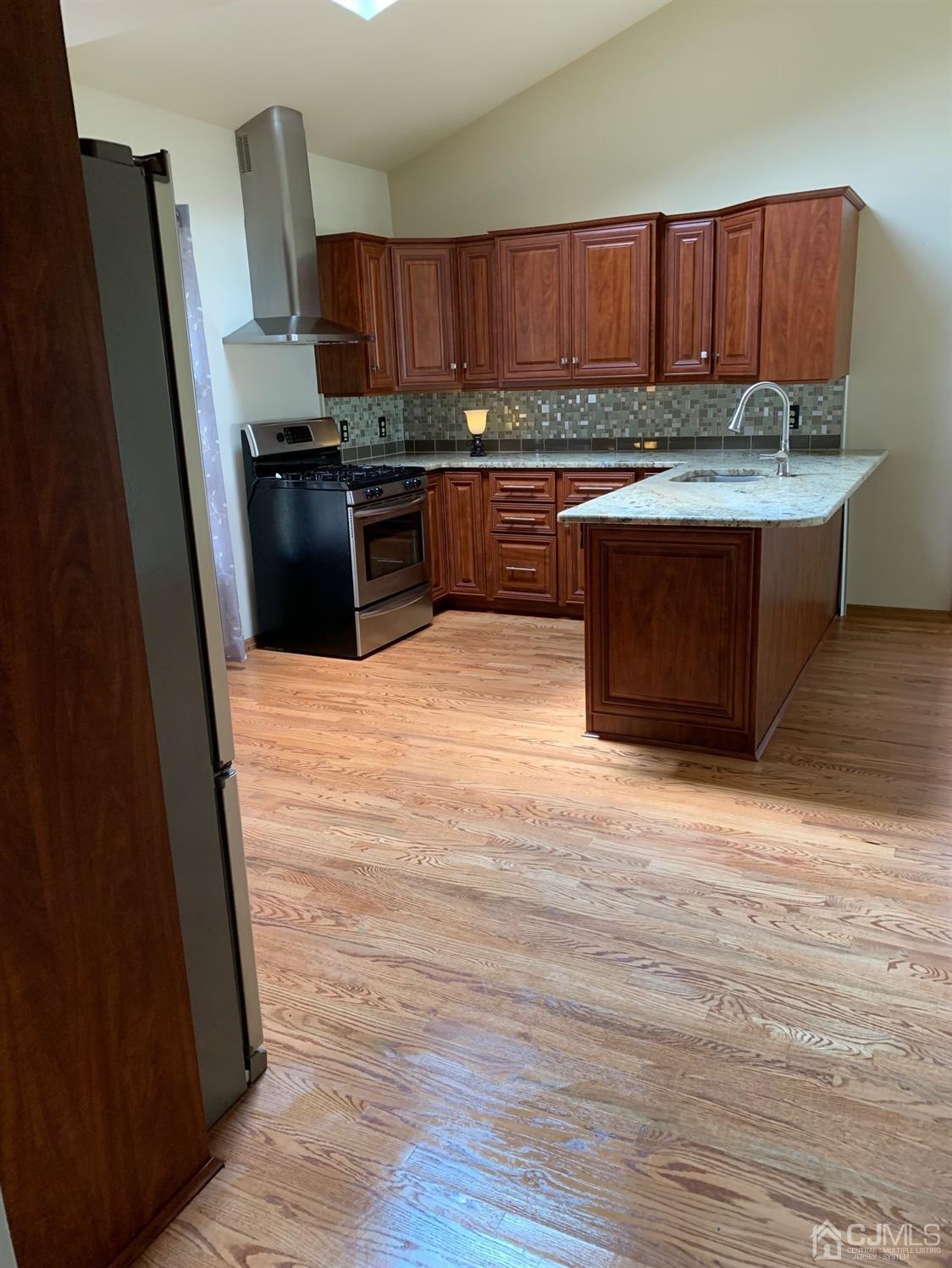 5 Princeton Road Old Bridge, NJ 08859 - Photo 5 of 20 a kitchen with stainless steel appliances granite countertop a stove top oven a sink and a refrigerator