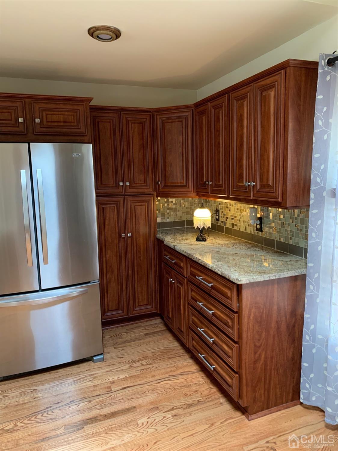 5 Princeton Road Old Bridge, NJ 08859 - Photo 6 of 20 a kitchen with granite countertop wooden cabinets and stainless steel appliances