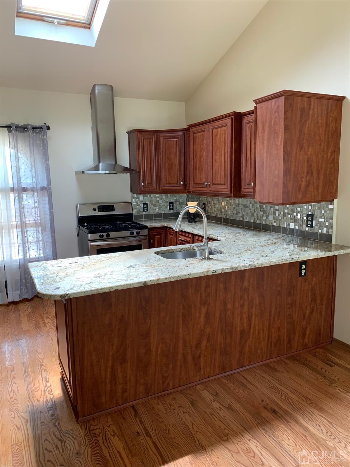 5 Princeton Road Old Bridge, NJ 08859 - Photo 7 of 20 a kitchen with stainless steel appliances granite countertop a sink a stove a counter space and cabinets
