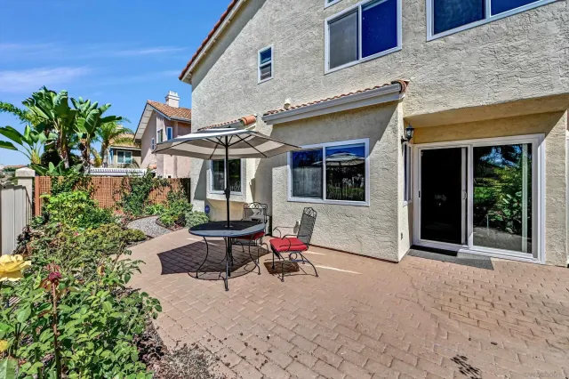 a view of patio with a chairs and table in a patio