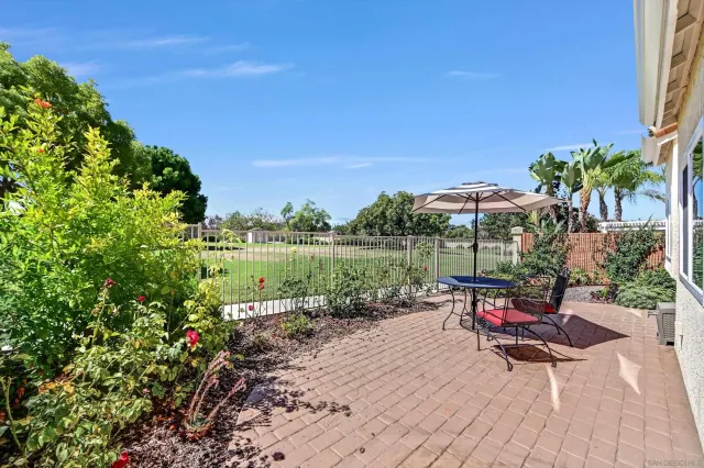 a view of a lake with a table and chairs