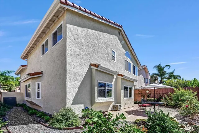a front view of house with a garden